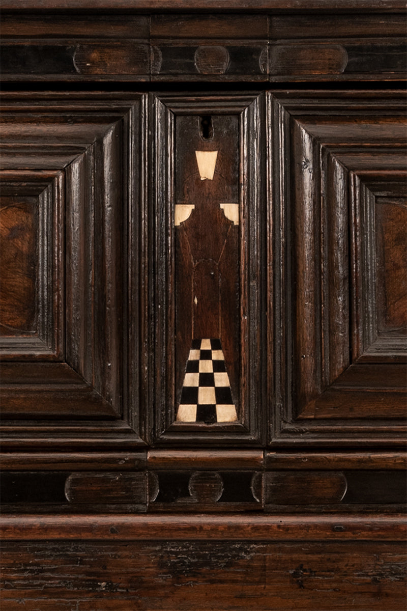 Closeup of the front of a baroque barleytwist inlaid cabinet