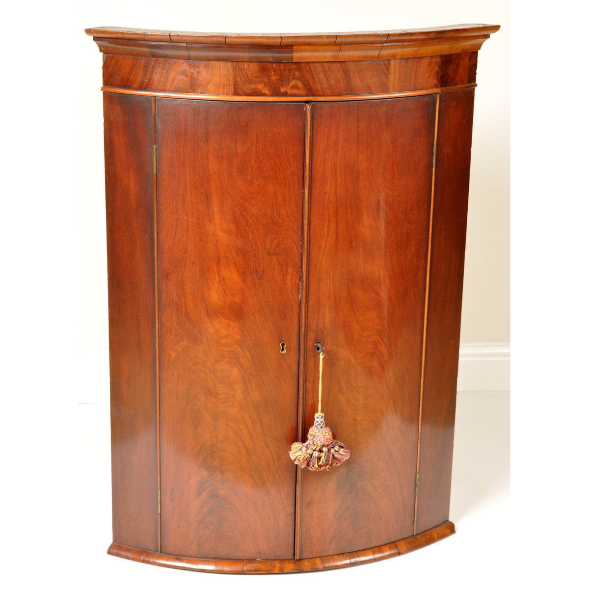Antique English Georgian Flame Mahogany Bow-Fronted Corner Cabinet, circa 1780